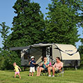 Family camping and playing with bubbles while enjoying their 2016 Sonic SN234VBH Travel Trailer - Vertical