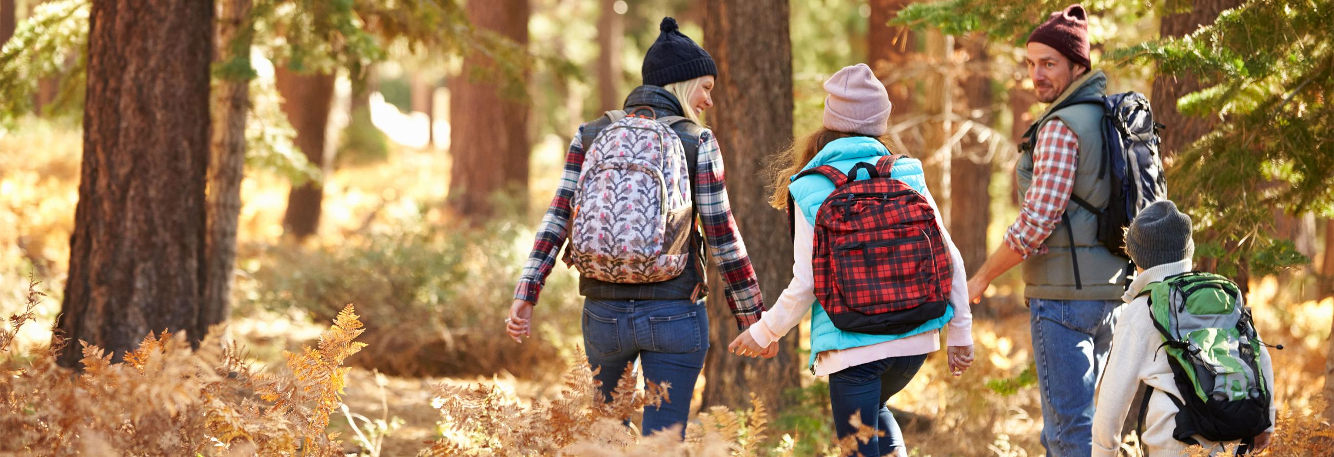 Family hiking while enjoying their 2017 Sonic Travel Trailer