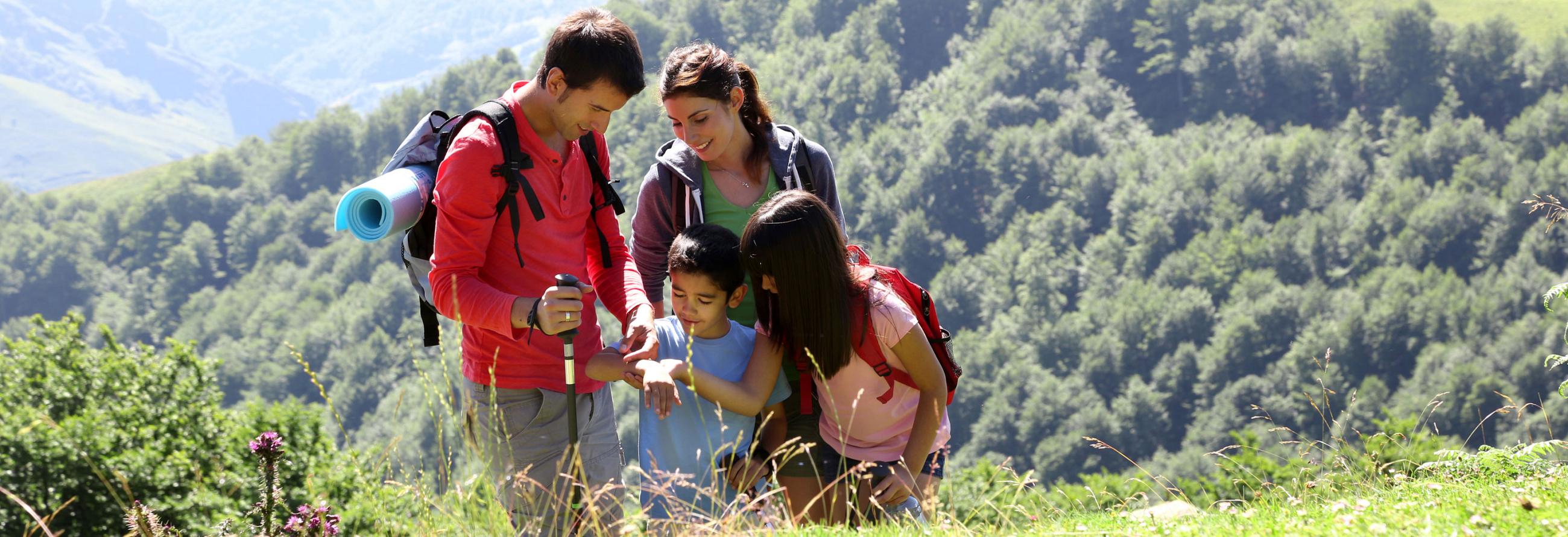 Family hiking outdoors with their 2017 SportTrek Travel Trailer