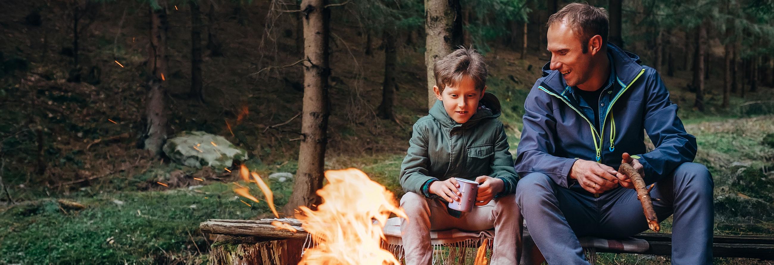 Father and son by campfire