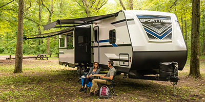 2020 Venture RV SportTrek ST327VIK Travel Trailer with couple at campsite